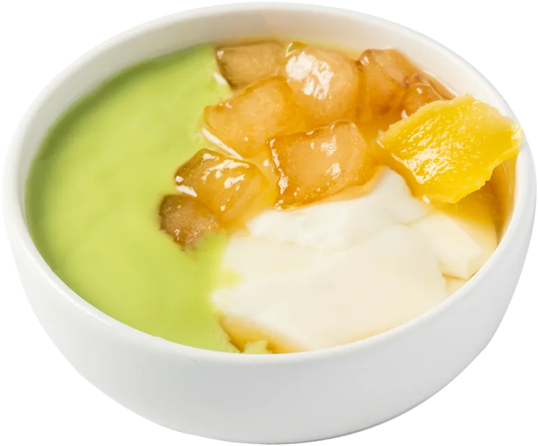 Bowl of pandan cream and coconut tofu pudding topped with golden pieces