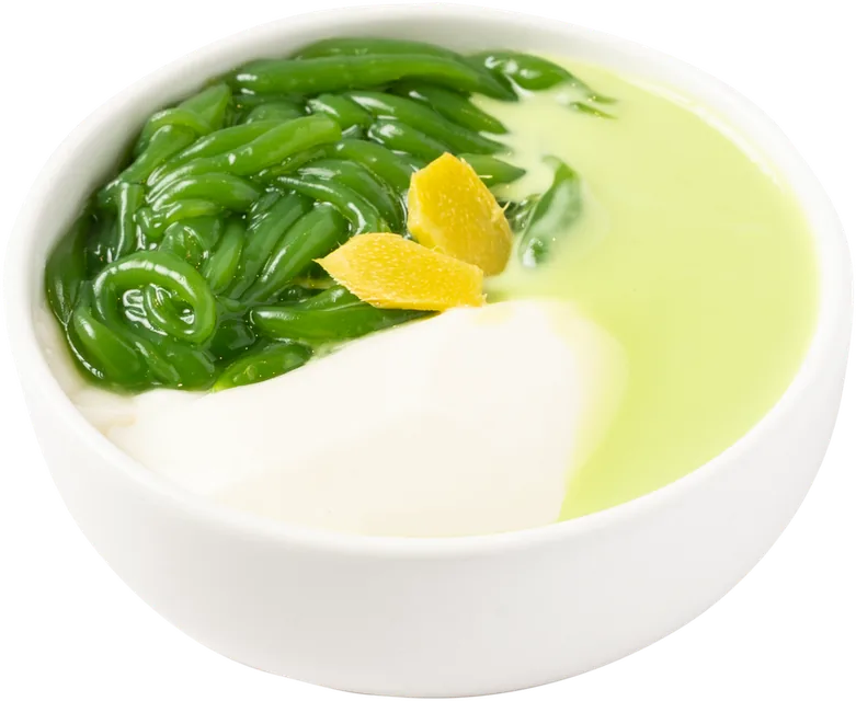 Bowl of tofu pudding with green pandan jelly and pandan cream